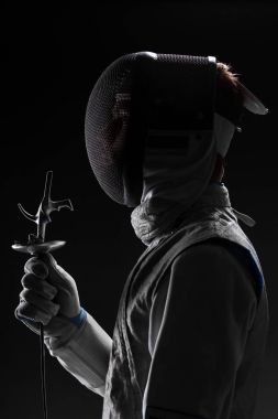 Male fencer with Mask holding the sword in front of his clipart