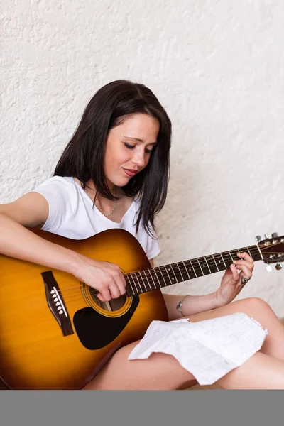Mulher tocando guitarra acústica — Fotografia de Stock