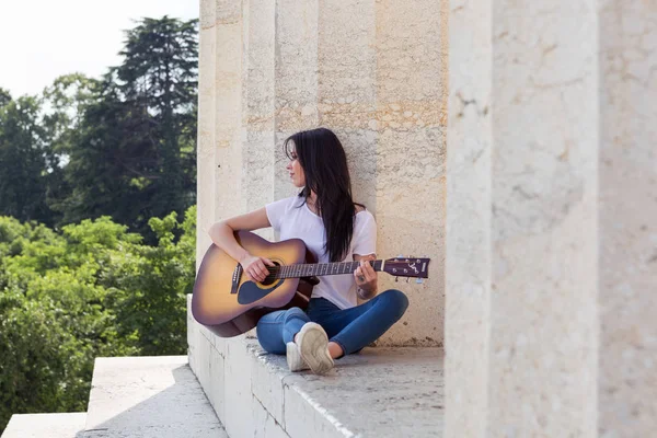 Akustik gitar çalmak gülümseyen güzel kadın