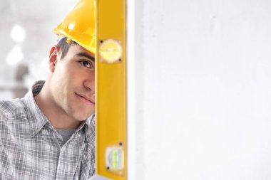 Handsome young architect checking level