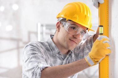 Handsome young architect checking level