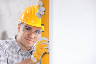 Handsome young architect checking level