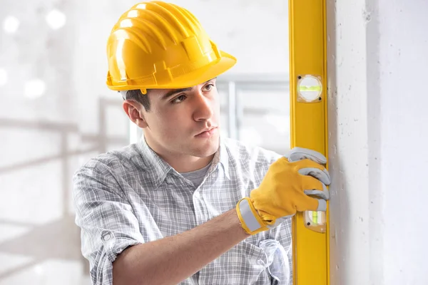 Handsome young architect checking level