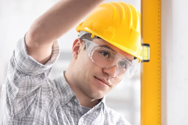 Handsome young architect checking level