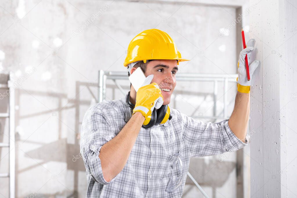 Builder talking on his mobile phone on site