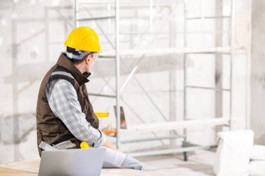 Builder or contractor using a mobile phone on site
