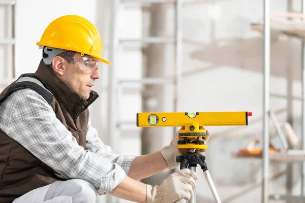 Construtor ou trabalhador ajustando um nível de espírito — Fotografia de Stock