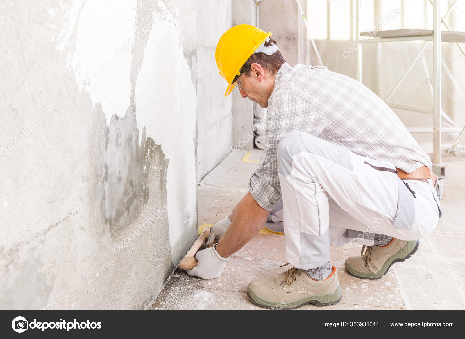 Builder Applying New Plaster Wall Indoors Covering Damp Stain