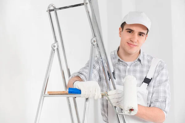 Friendly Young Painter Decorator Overalls White Cap Leaning Ladder Smiling — Stock Photo, Image