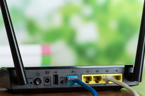 Connected connectors of a black router in a bright office — Stock Photo, Image