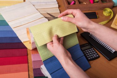 Kabin perdeleri. Satıcı perdeler için kumaş örnekleri gösteriyor.