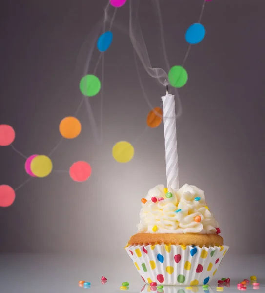 Festive birthday cupcake with a candle on bright background — Stock Photo, Image