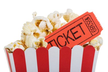 Popcorn in big box with movie tickets, isolated on white. clipart
