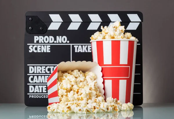 Popcorn in boxes and spilled, poppers on gray background. — Stock Photo, Image