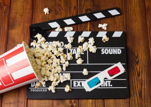 Black with white letters party poppers, box spilled popcorn-and — Stock Photo, Image