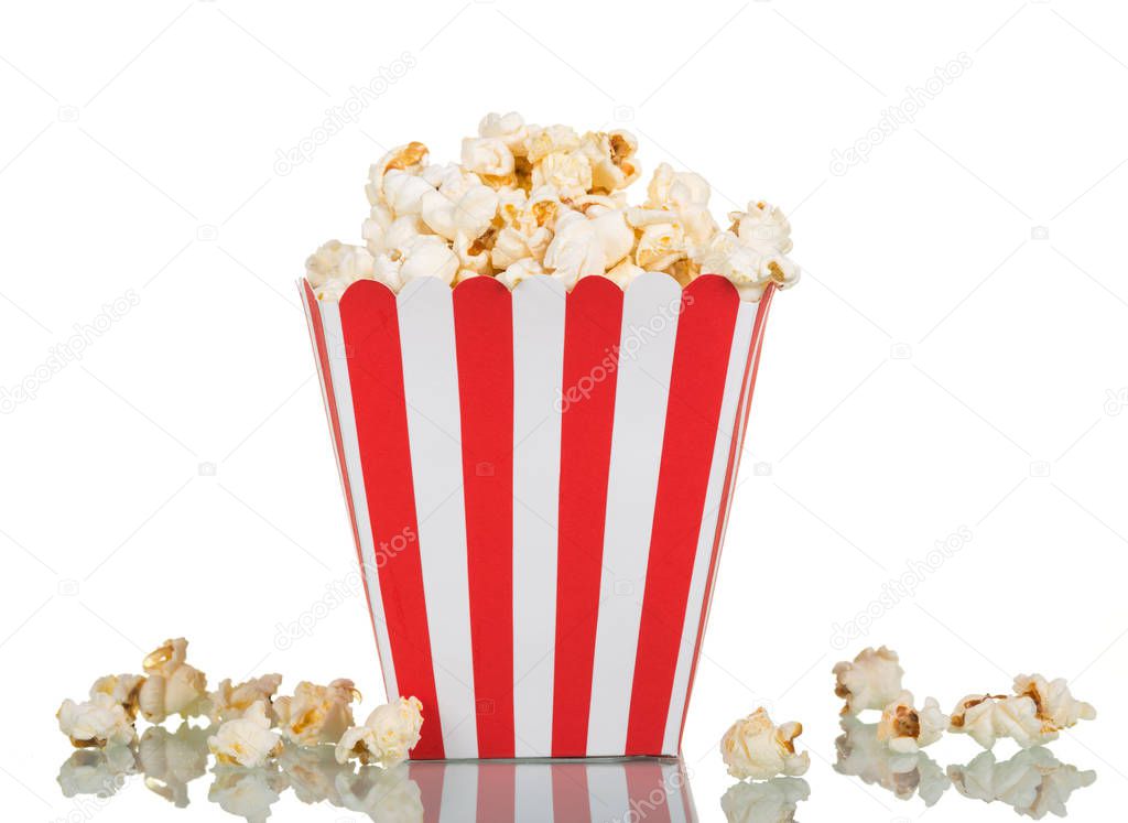 Popcorn in large square box and near isolated on white.