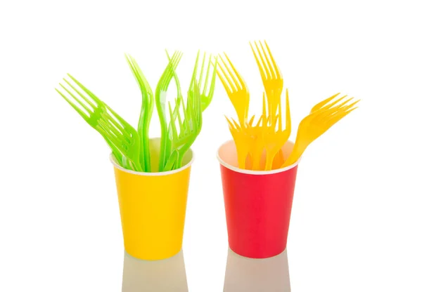 Yellow and light green forks are in colorful plastic cups — Stock Photo, Image