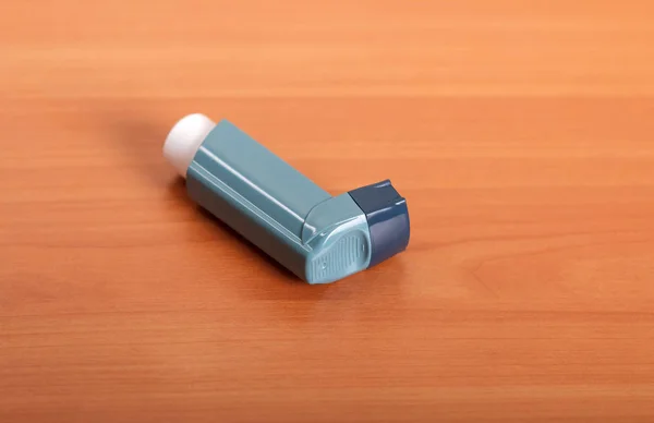 Small pocket inhaler on the background of table — Stock Photo, Image