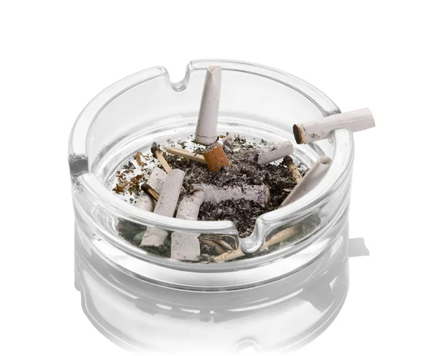 Cigarette butts, ashes, burnt matches in a glass ashtray isolated on white. Close-up — Stockfoto