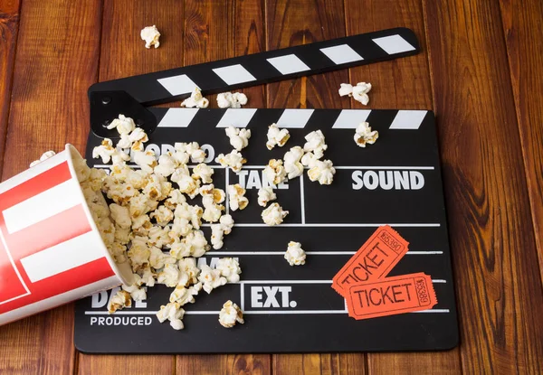 Black with white letters party poppers, box spilled popcorn — Stock Photo, Image