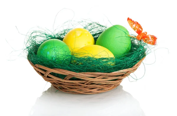 Colored Easter eggs in basket isolated on white background. — Stock Photo, Image