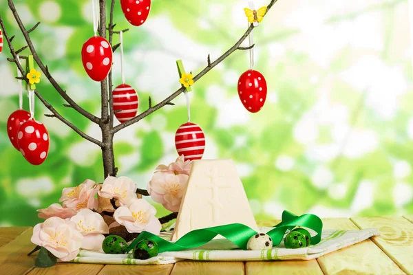 Easter eggs on branch and cloth, cheese dessert, flowers, butter — Stock Photo, Image