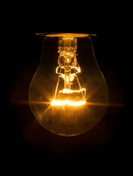 A bulb of incandescence is included isolated on black background — Stock Photo, Image