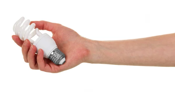 Una mano femminile tiene la lampadina fluorescente isolata su bianco . — Foto Stock