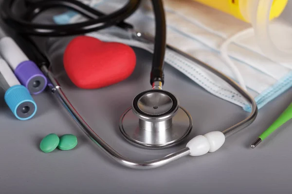 Medical stethoscope, pills, heart, vacuum tube, thermometer — Stock Photo, Image