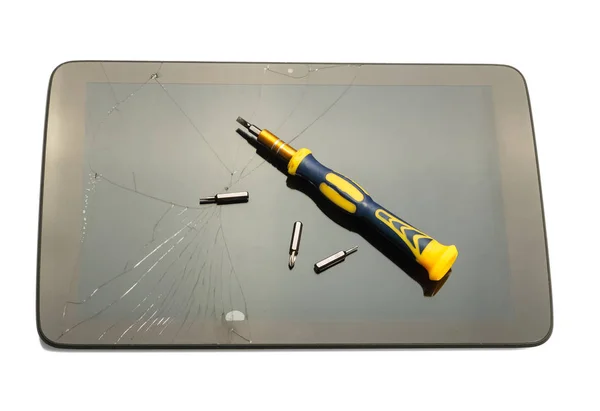 Broken digital tablet, and screwdriver bits isolated — 스톡 사진