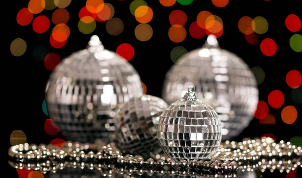 Mirror balls and beads, on a black sparkling background — Stock Photo, Image