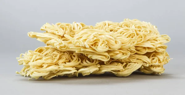 A stack of egg noodles on grey. — 스톡 사진