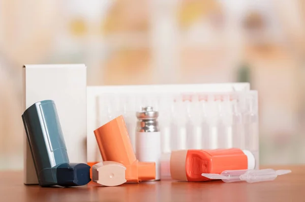 Three inhaler aerosol box and medicine on abstract pink. — Stock Photo, Image