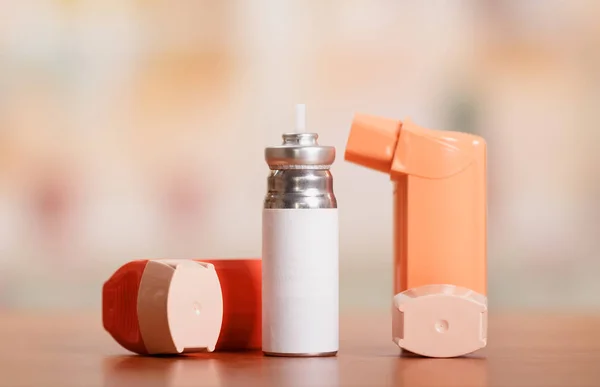 Two of the asthma inhaler and medication at the abstract pink. — Stock Photo, Image