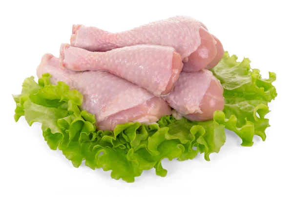 Raw chicken legs and lettuce leaves isolated on white. Stock Photo