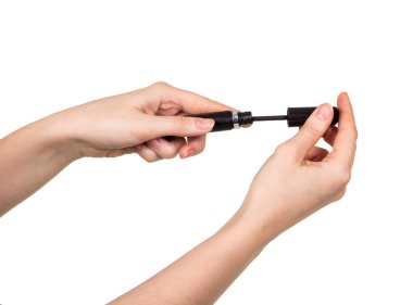 Mascara in female hands isolated on white.
