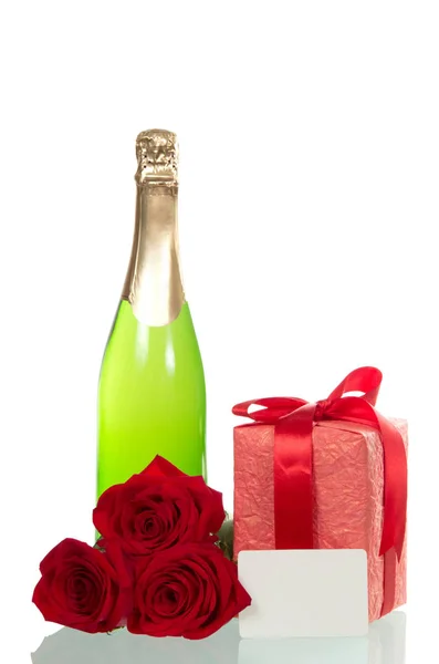 Gift box, flowers, bottle of wine on white — Stock Photo, Image