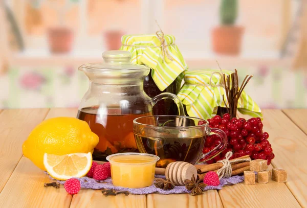 Pitcher with tincture, cup with tea, honey and lemon — Stock Photo, Image