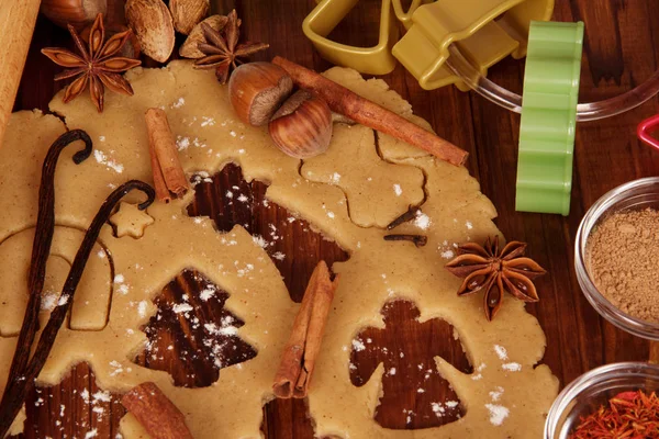 Formed biscuits, spices, molds on a wooden table — Stock Photo, Image