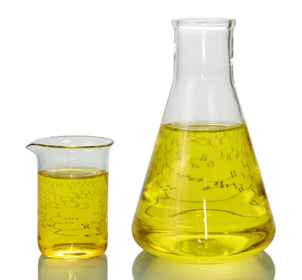 A chemical flask, a beaker with yellow liquids — Stock Photo, Image