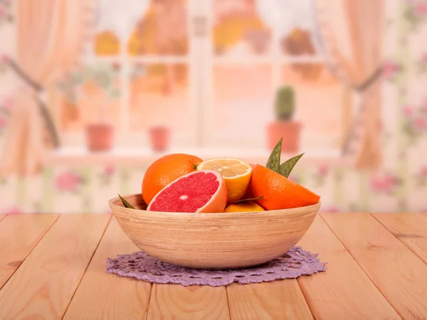 Ganze und geschnittene Grapefruits, Zitronen und Orangen mit Blättern — Stockfoto
