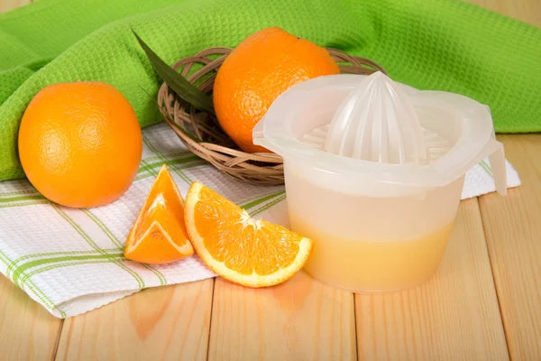 Pressa Mano Con Succo Spremuto Arancione Nel Cestino Tavolo Legno — Foto Stock