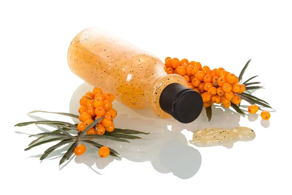 Branches with sea buckthorn berries and bottle — Stock Photo, Image