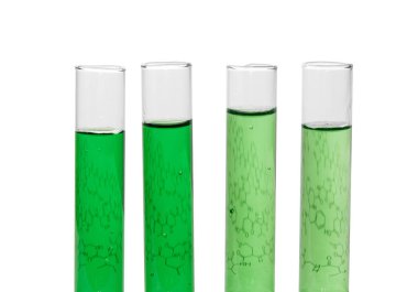 Four test tubes with green liquids 