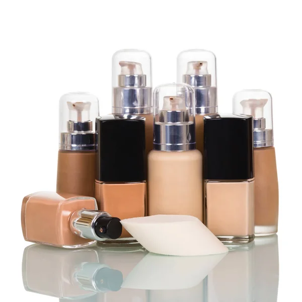 Bottles with foundation of different tones, one open — Stock Photo, Image