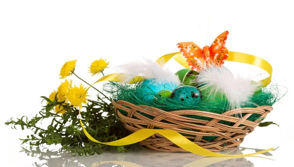 Colored Easter eggs in basket, grass, butterfly isolated — Stock Photo, Image