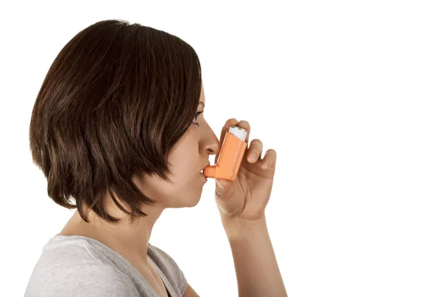 吸入器と薬を使用する女性は喘息発作を軽減します。 — ストック写真