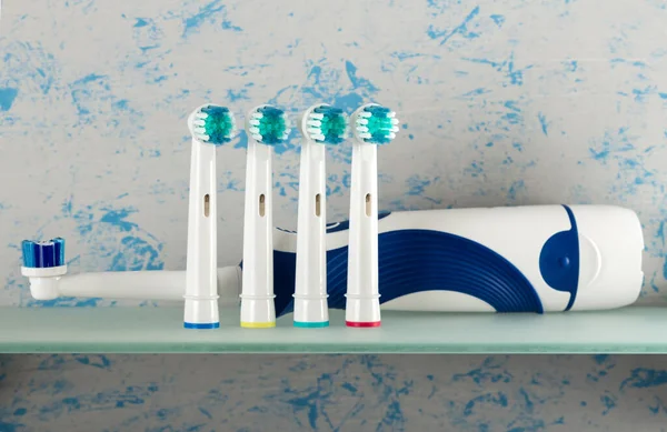 Electric Toothbrush Replaceable Nozzles Different Colors Glass Shelf — Stock Photo, Image