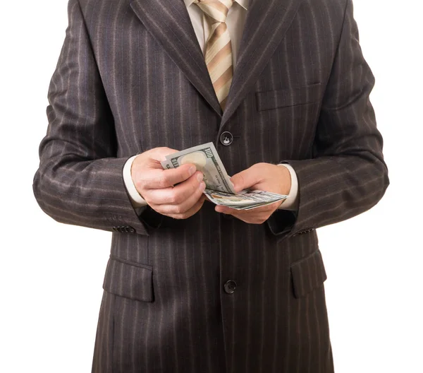 De man in het pak gelooft dollars geïsoleerd op wit. — Stockfoto