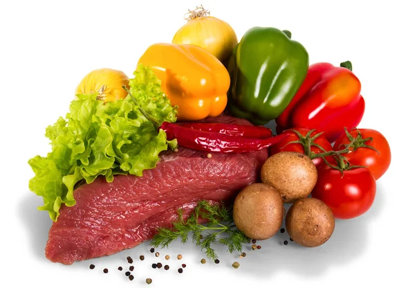 Piece of raw beef, tomato, mushrooms, lettuce, dill, onion, bulg Stock Image